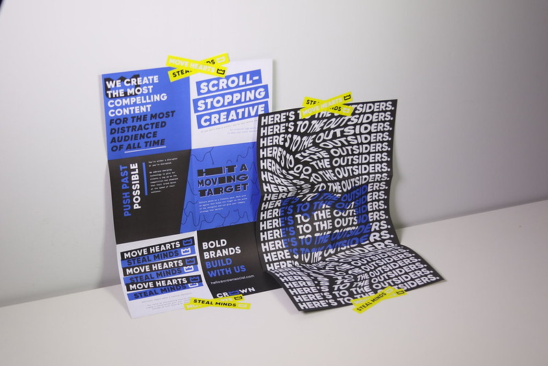 Poster saying 'bold brands build with us' and 'here's to the outsiders.'